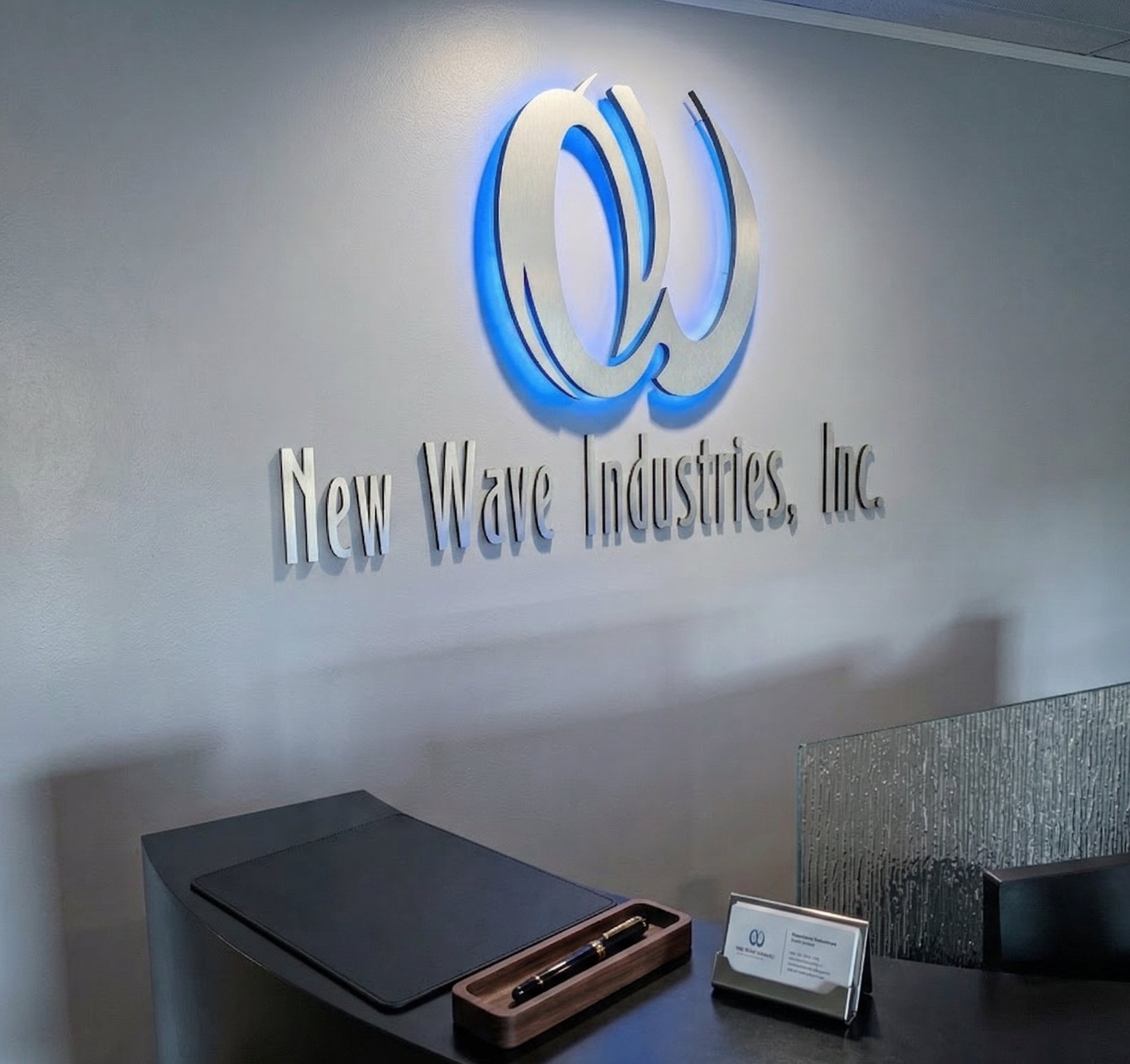 New Wave Industries, Inc. signage in the office lobby